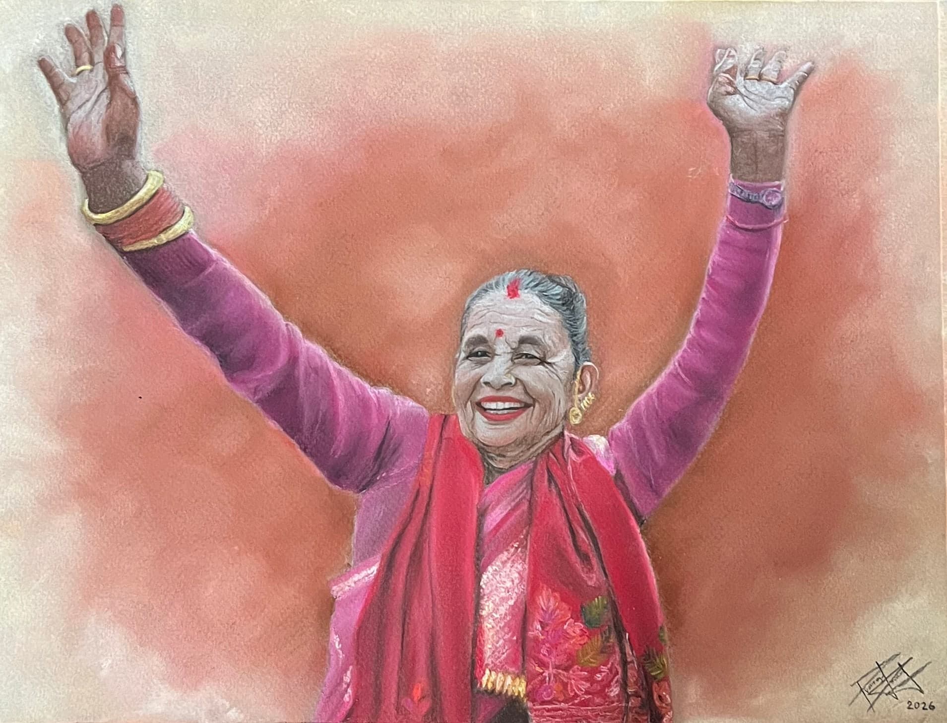 An elderly Nepali woman in a pink blouse and red shawl, with a red tika on her forehead, laughs with both arms raised against a soft rose background.