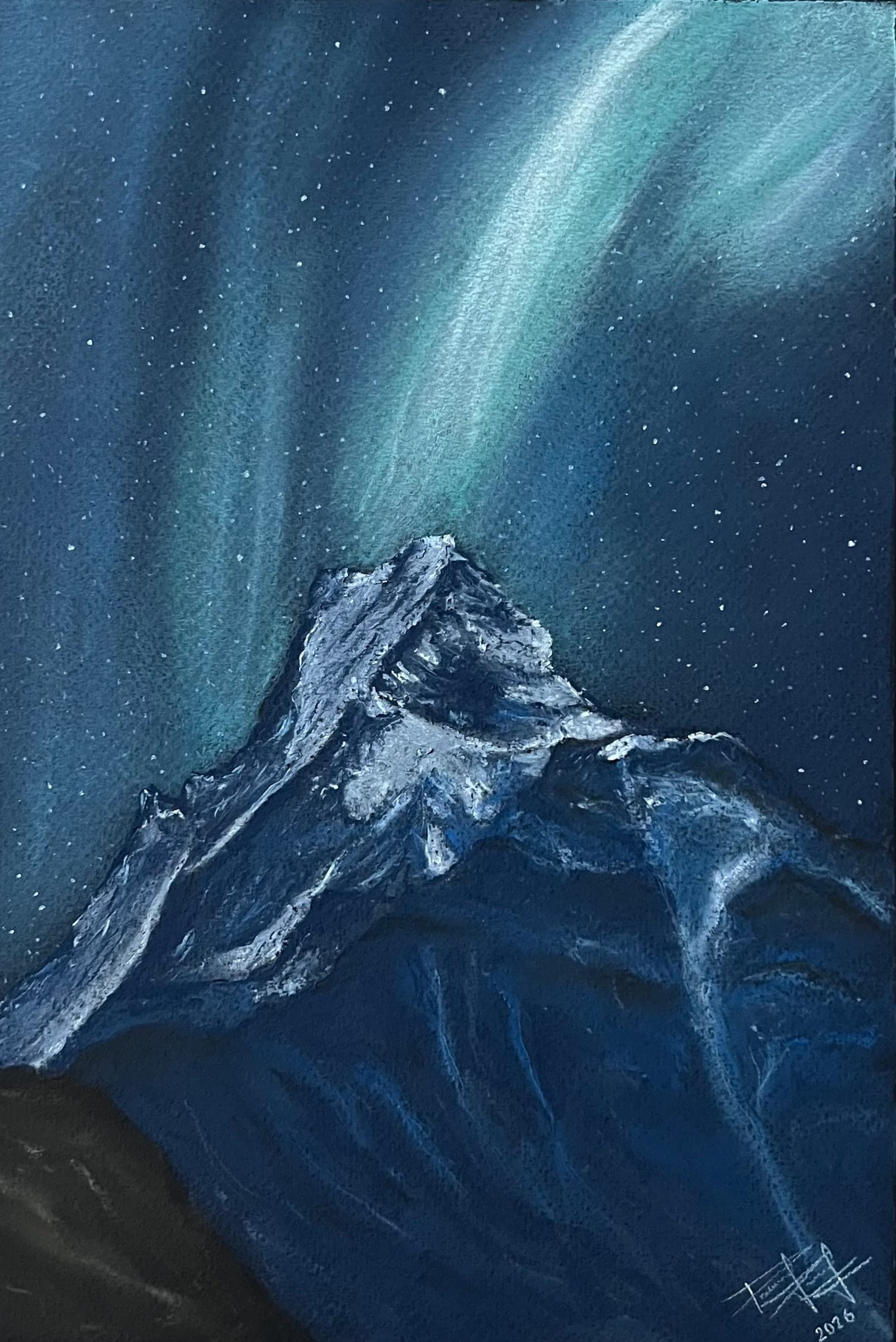 A sharp snow-covered peak rises into a deep blue night sky filled with stars and ribbons of green-white aurora.